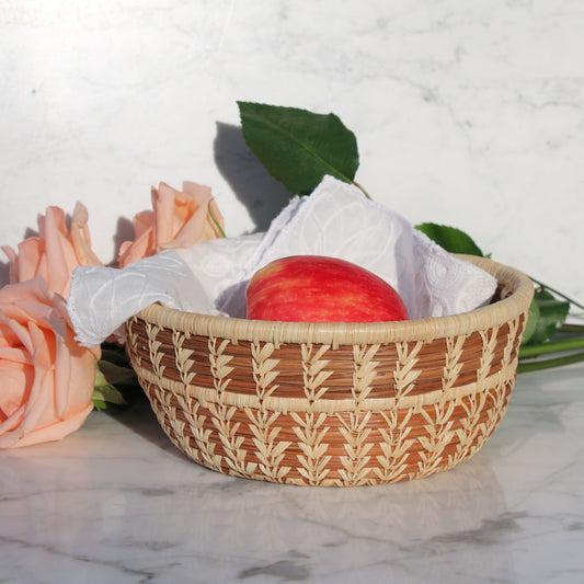 natural-fiber-brown-wicker-fruit-basket-bowl holding apple